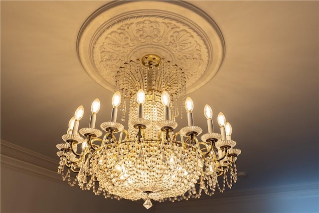 interior details featuring a notable chandelier and crown molding