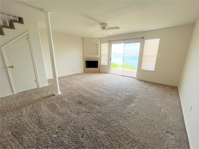 unfurnished living room featuring carpet flooring and ceiling fan