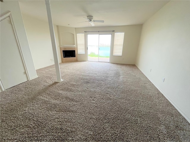 unfurnished living room featuring carpet floors and ceiling fan