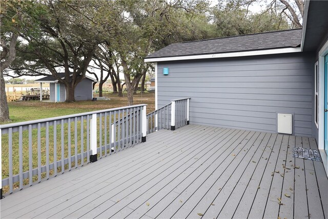 wooden terrace featuring a yard