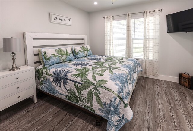 bedroom with dark wood-type flooring