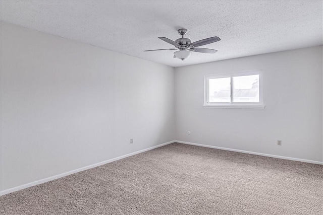 unfurnished room with a textured ceiling, carpet flooring, a ceiling fan, and baseboards