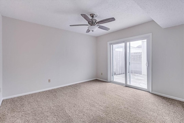 carpeted empty room with ceiling fan, a textured ceiling, and baseboards