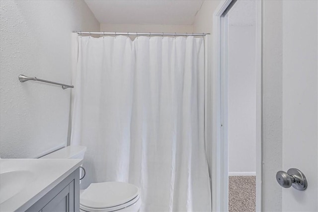 bathroom featuring toilet and vanity