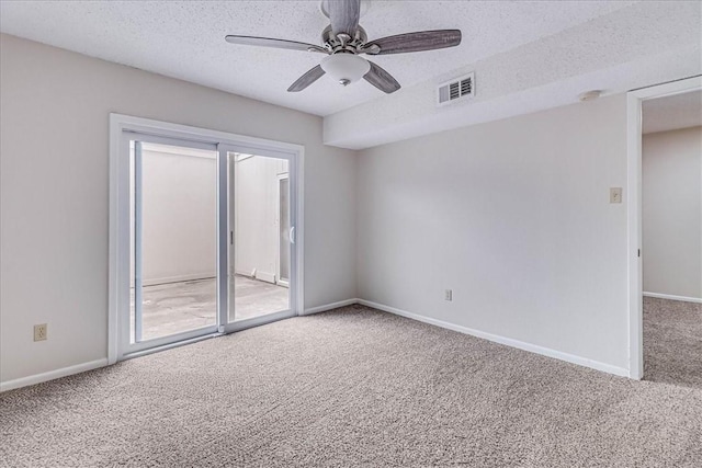 empty room featuring baseboards, visible vents, ceiling fan, carpet, and a textured ceiling