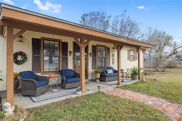 rear view of house with a porch and a yard