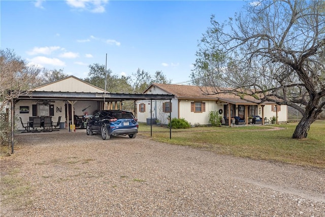 view of front of house with a front yard and a carport