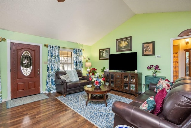 living room with dark hardwood / wood-style floors and lofted ceiling