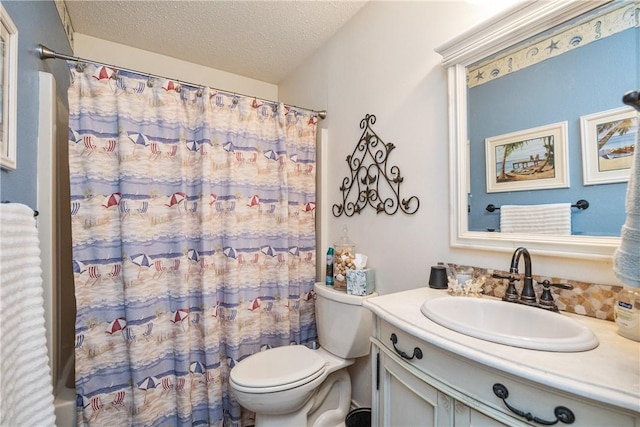 full bathroom with vanity, toilet, shower / bath combo with shower curtain, and a textured ceiling