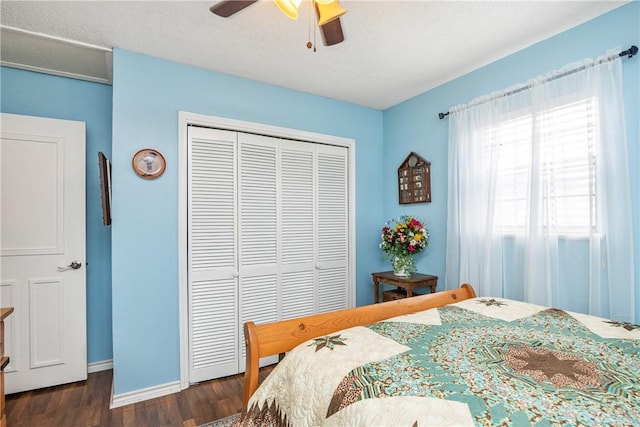 bedroom with ceiling fan, dark hardwood / wood-style floors, and a closet