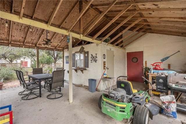 exterior space featuring ceiling fan, lofted ceiling, and concrete flooring