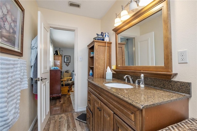 bathroom featuring hardwood / wood-style floors and vanity