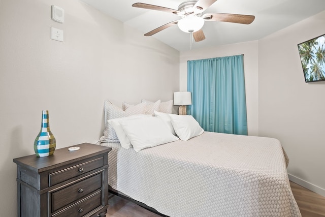 bedroom featuring dark wood-type flooring and ceiling fan