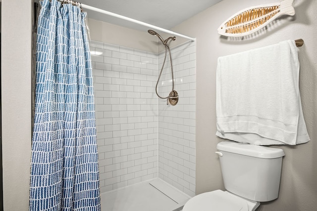 bathroom with walk in shower and toilet