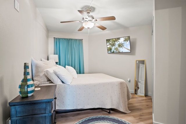 bedroom with hardwood / wood-style flooring and ceiling fan