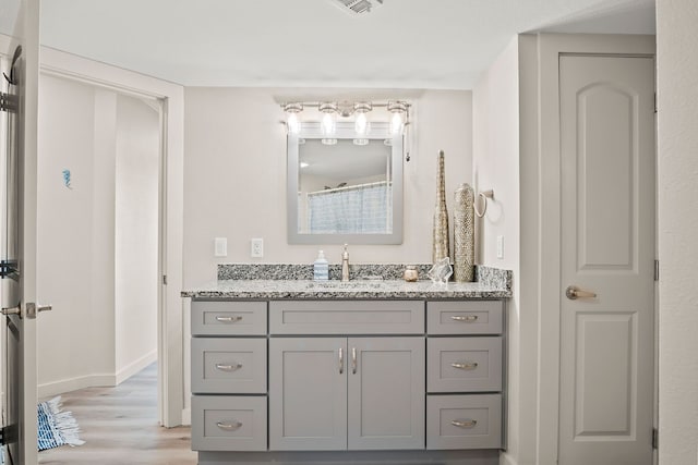 bathroom featuring wood-type flooring and vanity