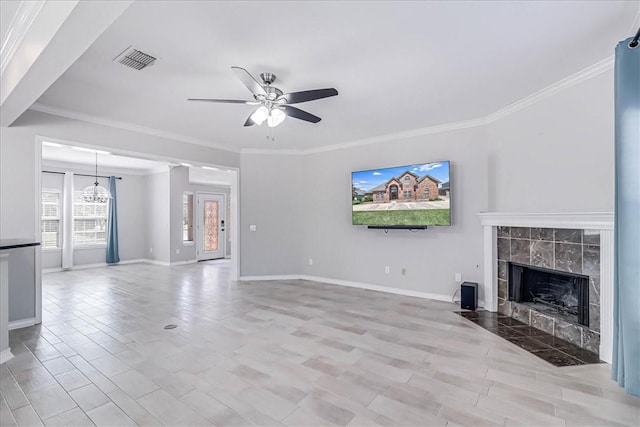 unfurnished living room with a tile fireplace, ceiling fan, and crown molding