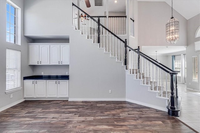 interior space with a notable chandelier, wood-type flooring, and high vaulted ceiling