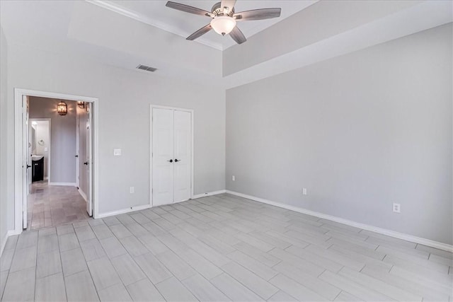 10 W Bar Le Doc Dr, Corpus Christi, TX 78414 - unfurnished bedroom featuring a raised ceiling, a ceiling fan, and light wood finished floors