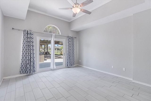 empty room featuring ceiling fan, a high ceiling, and ornamental molding