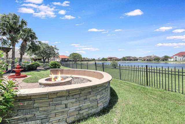 view of yard featuring a water view and a fire pit