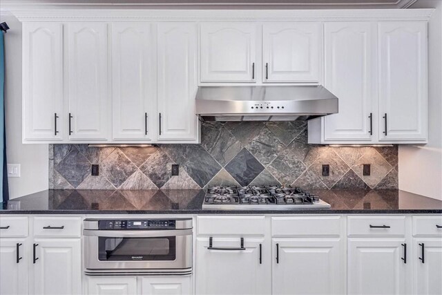 kitchen featuring white cabinets, ventilation hood, and stainless steel appliances