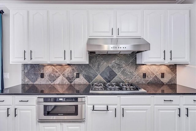 10 W Bar Le Doc Dr, Corpus Christi, TX 78414 - kitchen featuring under cabinet range hood, appliances with stainless steel finishes, white cabinets, and decorative backsplash