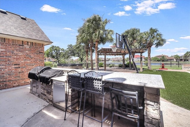 view of patio featuring an outdoor bar and an outdoor kitchen