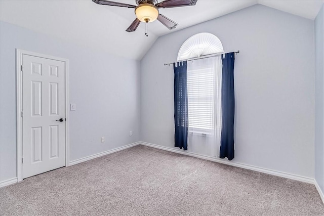 carpeted spare room with ceiling fan and lofted ceiling