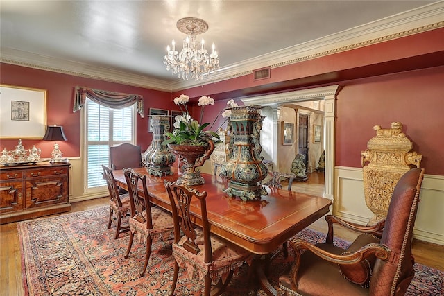215 Oleander, Corpus Christi, TX 78404 - dining room featuring a chandelier, wainscoting, wood finished floors, and ornamental molding