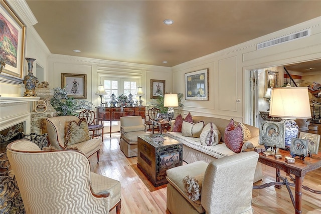 215 Oleander, Corpus Christi, TX 78404 - living room with a decorative wall, crown molding, a fireplace, and light wood-type flooring