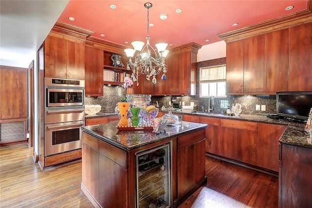 215 Oleander, Corpus Christi, TX 78404 - kitchen with oven, beverage cooler, a sink, wood finished floors, and a center island
