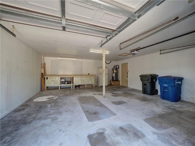 4753 Sierra Blanca Blvd, Corpus Christi, TX 78413 - garage with electric water heater, a garage door opener, and freestanding refrigerator