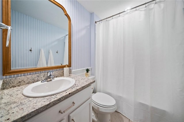 full bathroom featuring toilet, shower / bathtub combination with curtain, and vanity