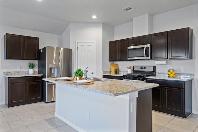 kitchen featuring appliances with stainless steel finishes, visible vents, a sink, and dark brown cabinetry