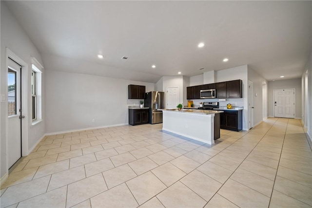 kitchen featuring light tile patterned floors, recessed lighting, light countertops, appliances with stainless steel finishes, and open floor plan