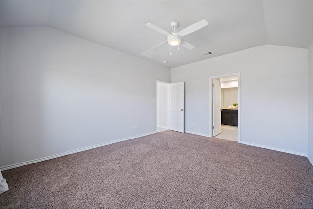 unfurnished bedroom with light carpet, vaulted ceiling, visible vents, and baseboards