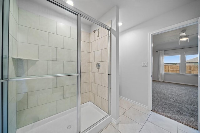 bathroom featuring a shower stall, baseboards, and tile patterned floors