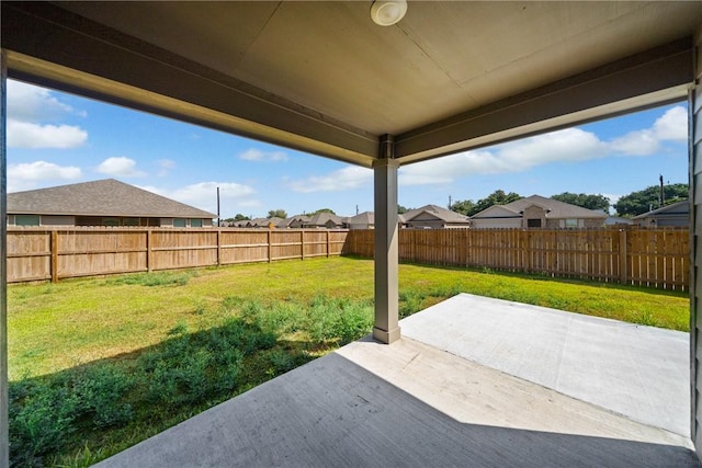 view of yard featuring a residential view, a patio area, and a fenced backyard