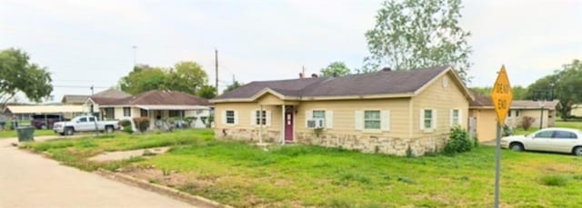 bungalow-style house with a front lawn and a carport