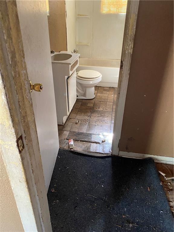 bathroom featuring toilet and vanity