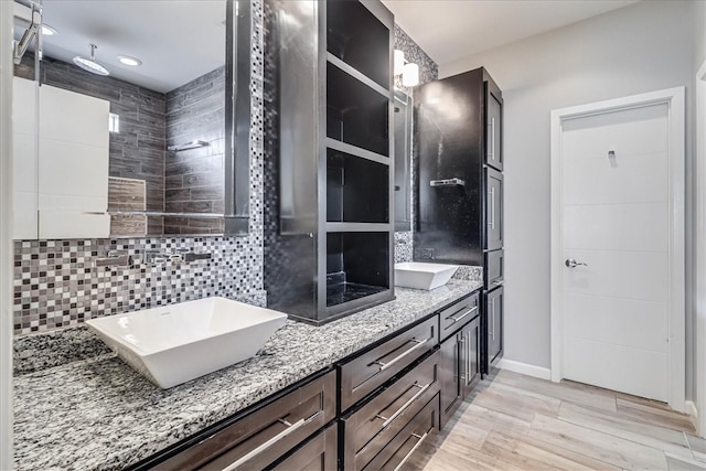 bathroom with decorative backsplash, vanity, and hardwood / wood-style flooring