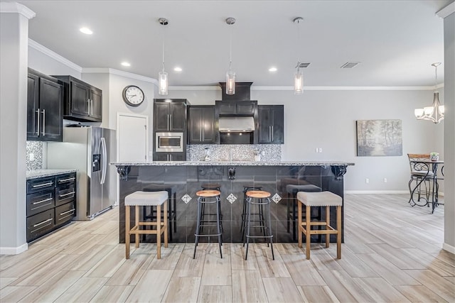 kitchen with light hardwood / wood-style floors, light stone countertops, hanging light fixtures, and appliances with stainless steel finishes