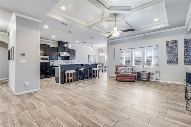 living room featuring ceiling fan, light wood-type flooring, ornamental molding, and coffered ceiling