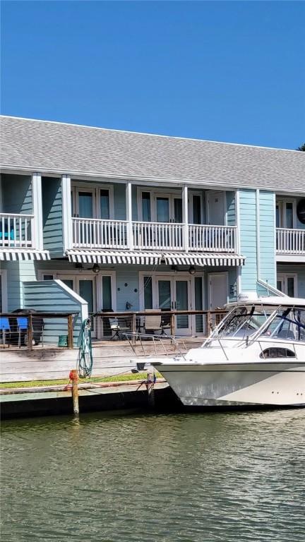 709 Lauderdale Dr, Rockport, TX 78382 - back of property with a water view and roof with shingles