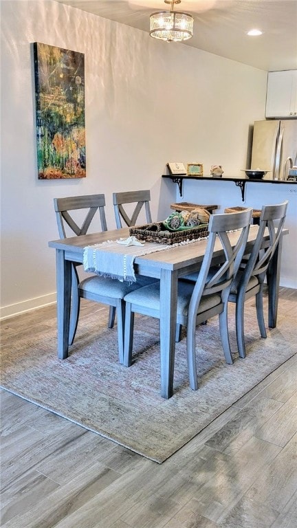 dining space with light hardwood / wood-style floors