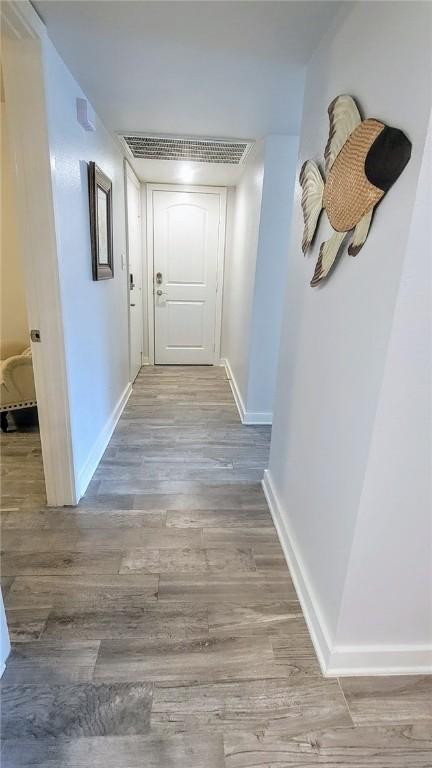 709 Lauderdale Dr, Rockport, TX 78382 - corridor with baseboards and wood finished floors