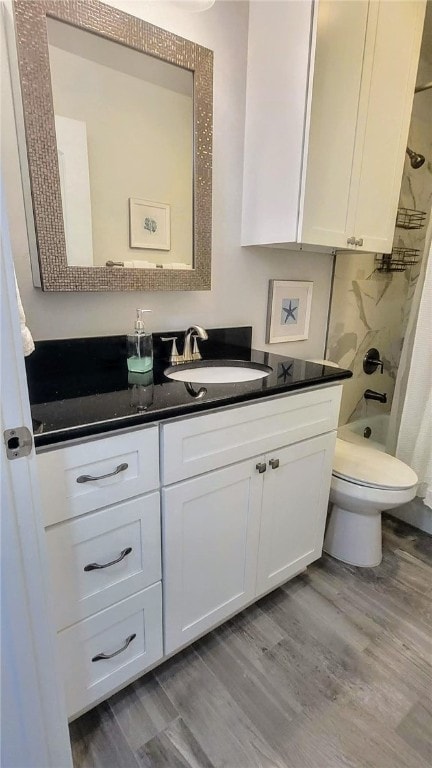 full bathroom with toilet, vanity, shower / bath combination with curtain, and wood-type flooring