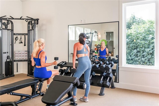 673 Center S Unit 21, Port Aransas, TX 78373 - exercise area featuring carpet floors, plenty of natural light, and baseboards