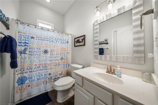 bathroom with vanity, toilet, and walk in shower